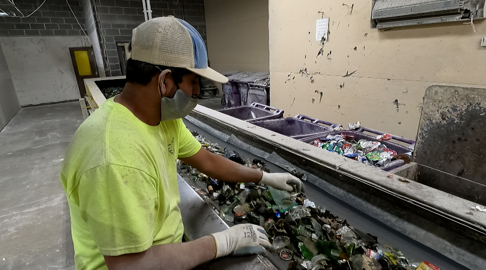 A Ripple Glass worker sorts through glass recycling