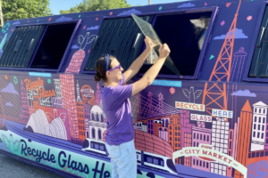 recycling glass in a dumpster glass recycling bin